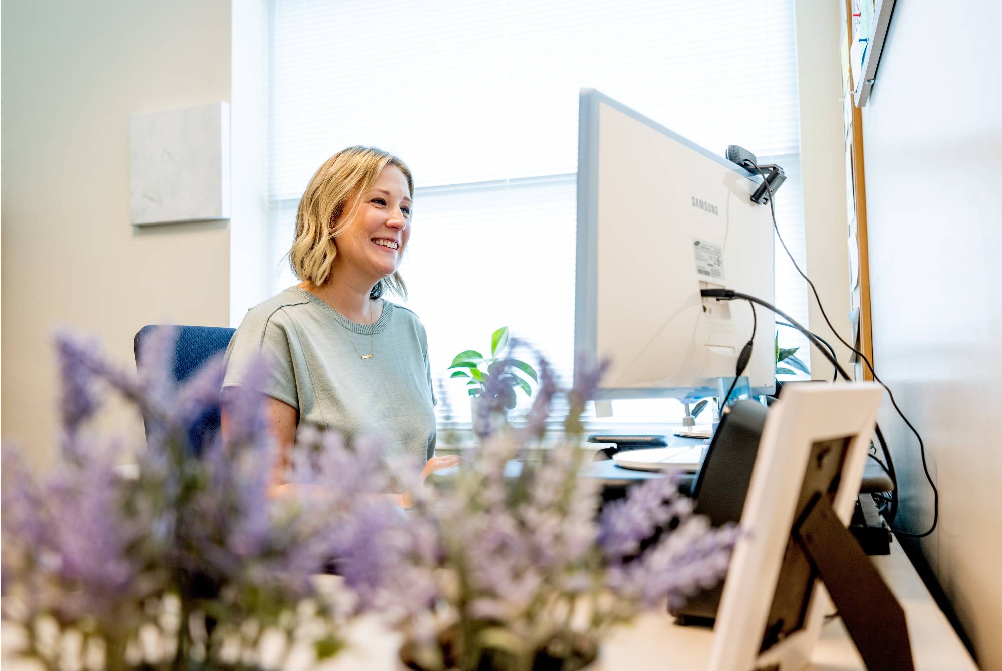 Kristen Vu smiles working at her computer